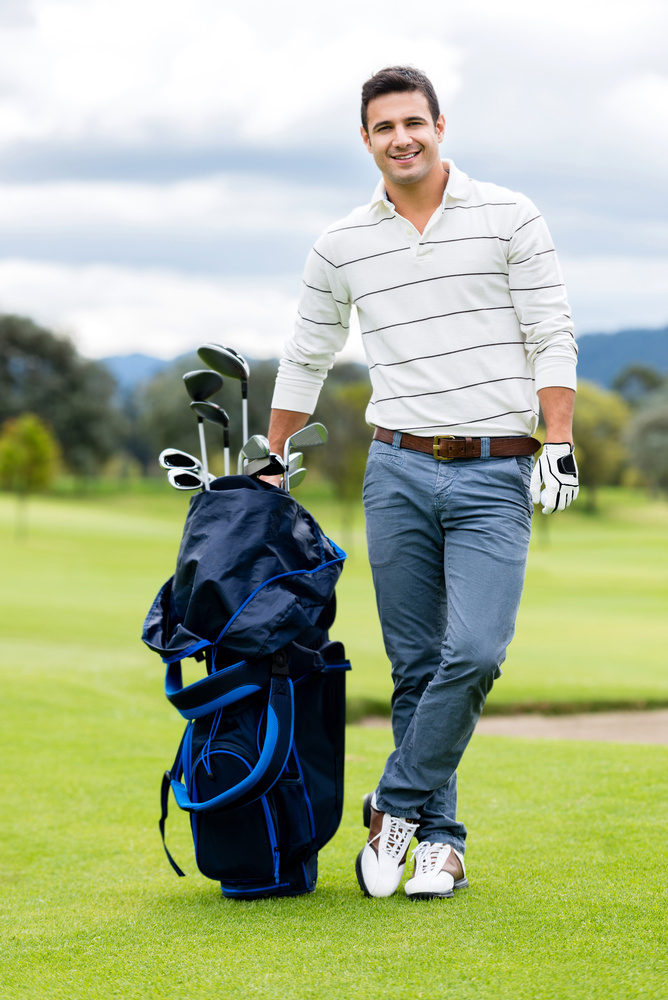 Male golf player at the course with a club sack Male golf player at the course with a club sack